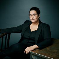 Photograph of author Carmen Maria Machado sitting in a chair